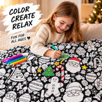 Girl coloring the Christmas blanket with markers